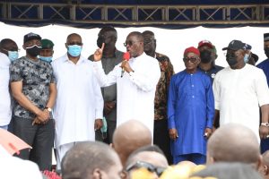 Delta Governor, Senator Dr. Ifeanyi Okowa (left) addressing the mammoth crowd of APC members who defected to the PDP in Aniocha/Oshimili Federal Constituency of the state, in Asaba on Thursday.