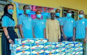  (Far Left) Rauda Musa Umar, Delegation Leader & Wheat Development Programme Officer, Crown Flour Mill (CFM), presenting CFM’s Food Donation to the Nasarawa Children’s Home, Kano, received by Malam Magaji, Assistant Director, Nasarawa Children’s Home (Middle) in commemoration of the 2021 World Food Day on Saturday, October 16, 2021.  