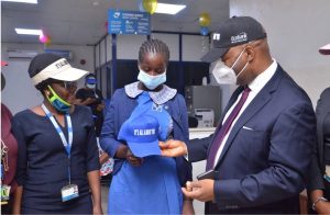 Managing Director/Regional Executive, Ecobank Nigeria Patrick Akinwuntan presenting a gift to Kehinde Adesogan, a student of Queens College.