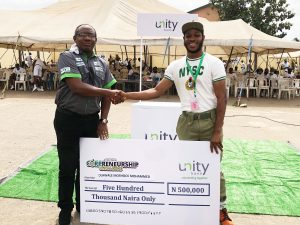 From left: Group Head, Retail, E-Business and SME Banking, Unity Bank Plc, Mr. Olufunwa Akinmade congratulating the star prize winner in Lagos NYSC camp, Olawale Moshood Mohammed.