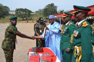 Chairman/Chief Executive of the National Drug Law Enforcement Agency, NDLEA, Brig. Gen. Mohamed Buba Marwa (Retd), (m) presenting the 'Marwa Award' to Major AC Ogbuogu (l), while the Chief of Army Staff, Lt. Gen. Farouk Yahaya (2nd r) and Commander, Infantry Corps, Major Gen. VO Ezugwu (r) watch in admiration.